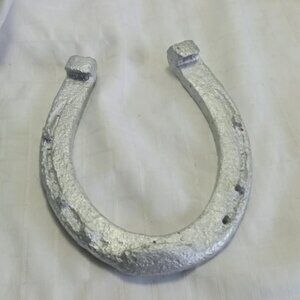 Real vintage 7 inches horse shoe spray painted in a silver color